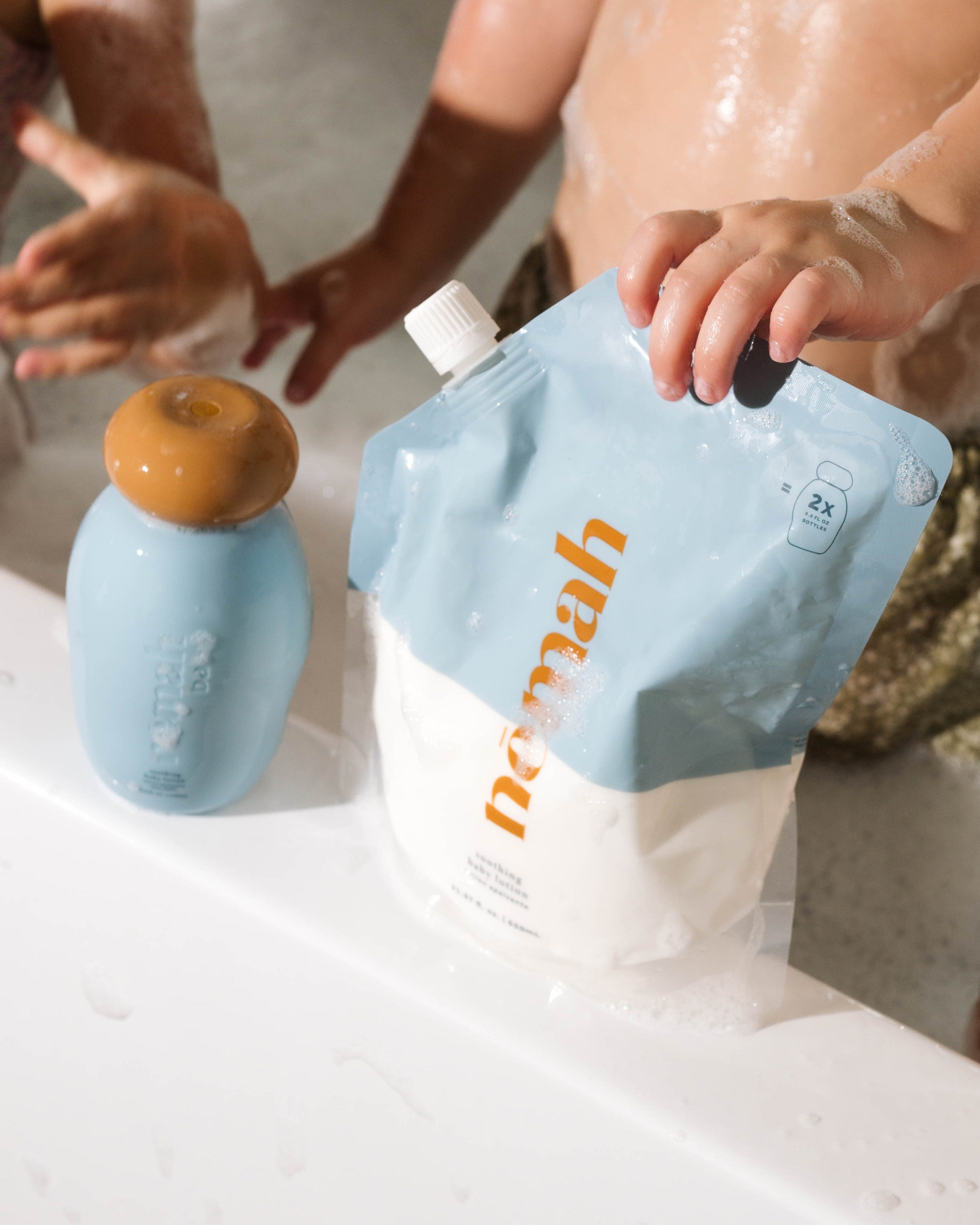 Children playing with bath products in a tub