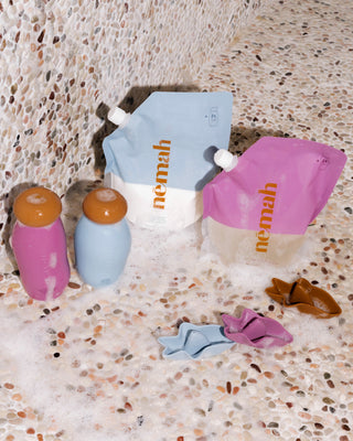 nemah Bath-Time Duo refill pouches (pink and blue) with caps and bath foam; 2x icon visible