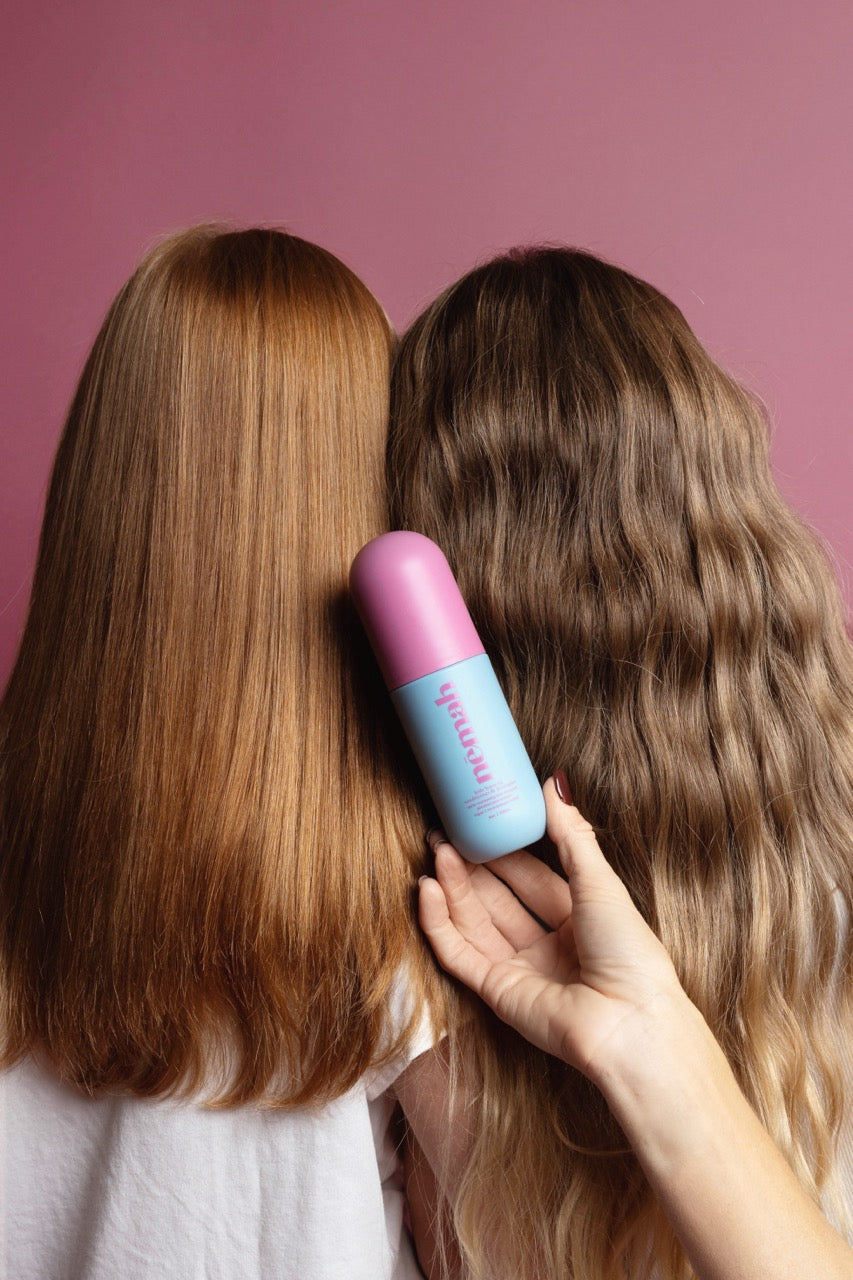 Two people with different hair textures, hand holding a hair product.