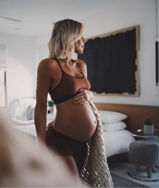Pregnant woman is touching her stomach