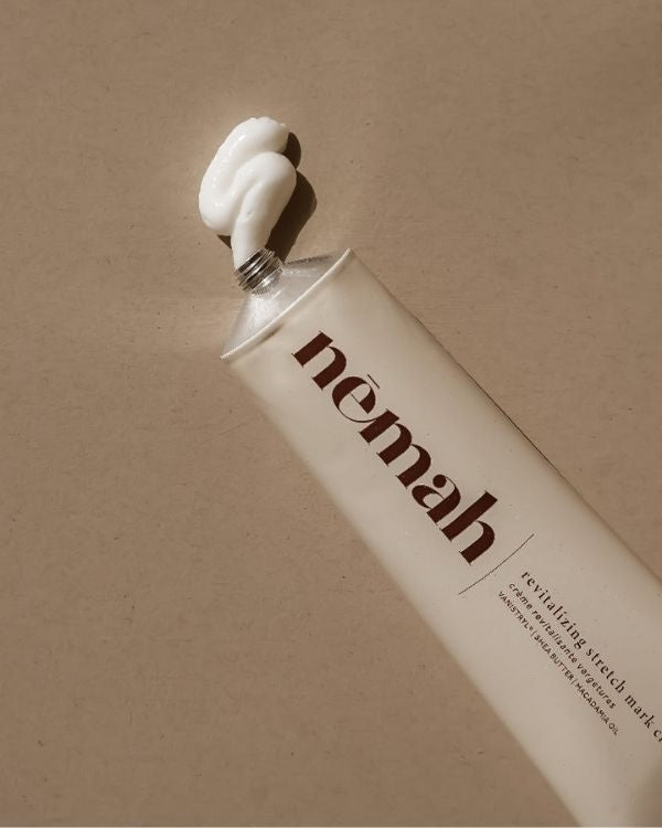 Tube of Nemah skincare cream with cream coming out