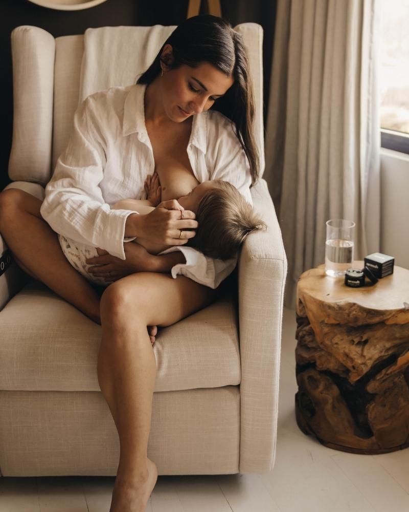 woman is breast feeding her baby 
